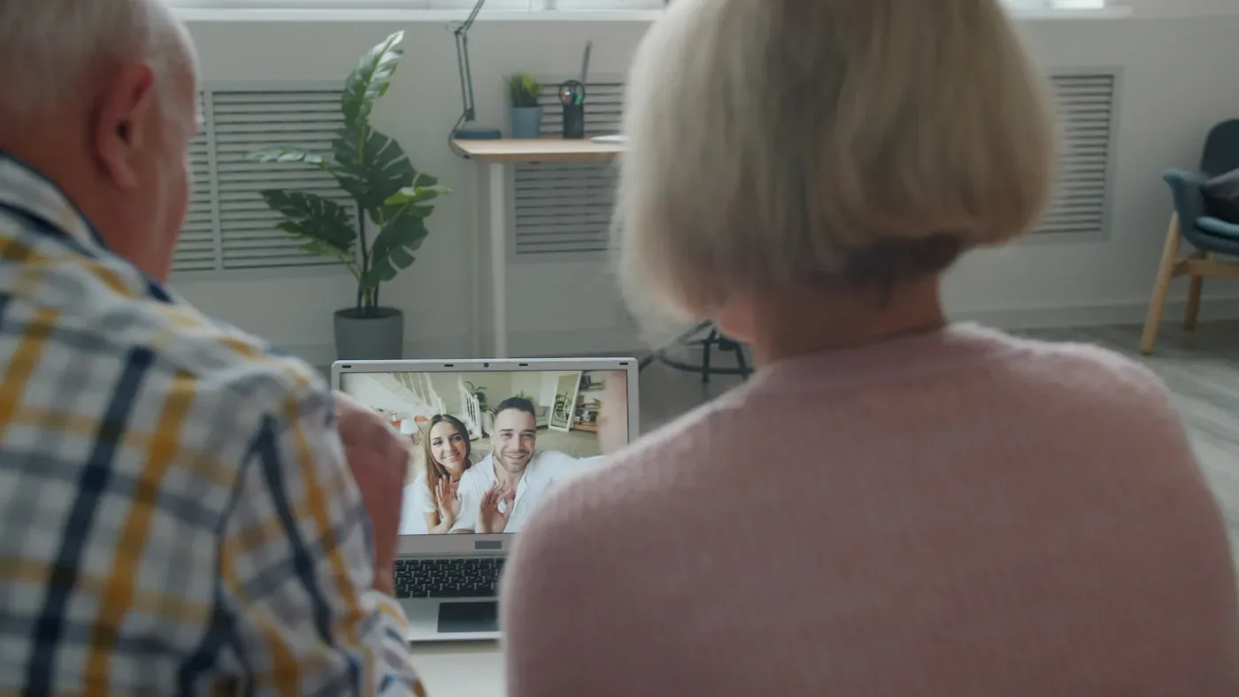 Senior couple video calling with family from home