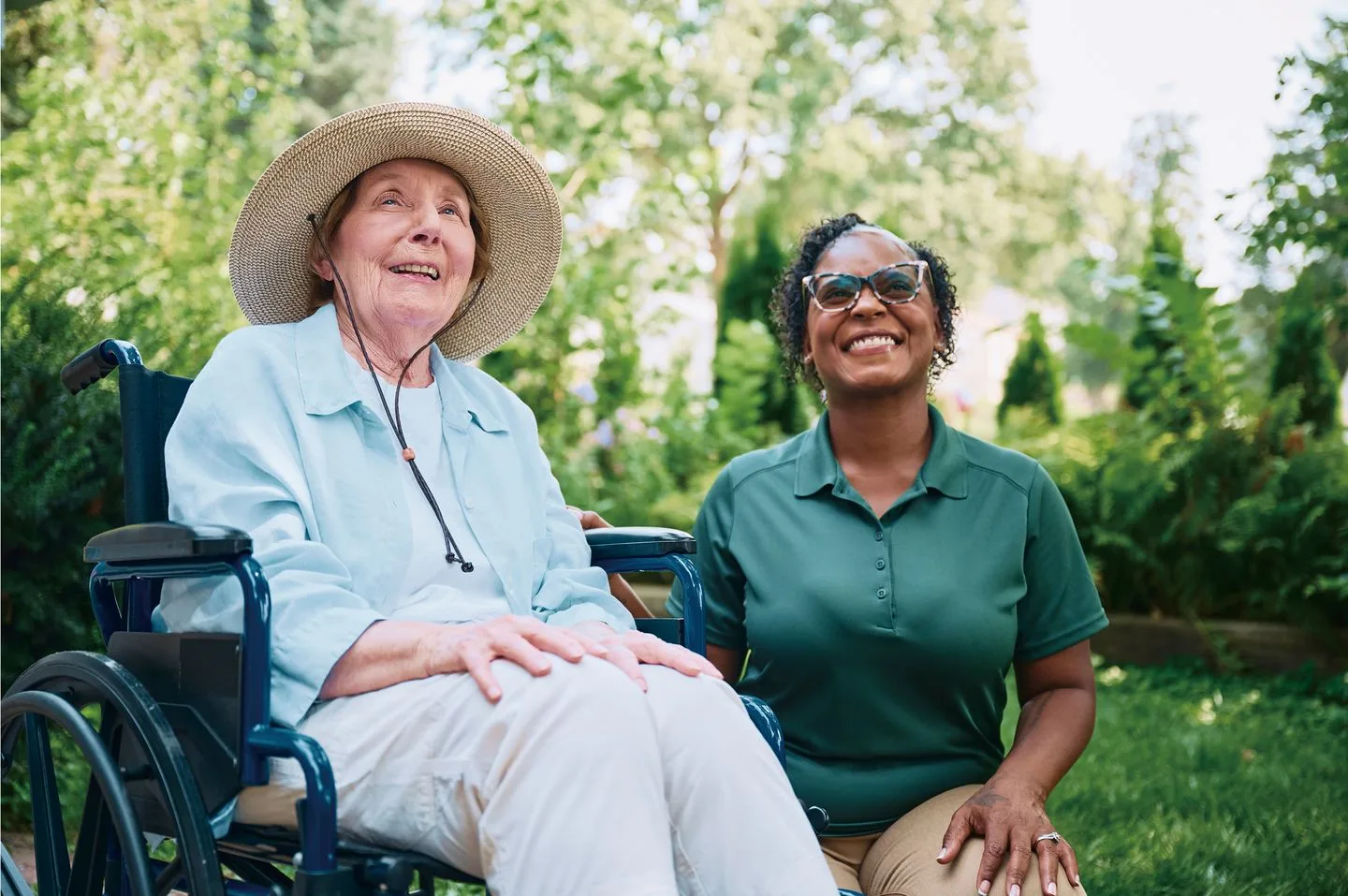A Home Instead care professional supporting an older adult using a wheelchair